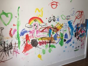 graffiti art painted by kids on wall of house during painting party prior to demolition of old house