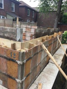 photo of forms for foundation walls of new house being filled