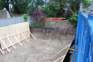 photo of excavated site with initial preparation for building of new foundation