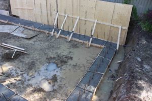 photo of cement-filled forms for footings of new house