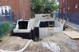 photo of waterproofing the foundation from front of house