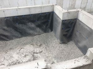 photo after stones poured into garage foundation floor