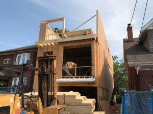 photo of front of house during framing of second floor