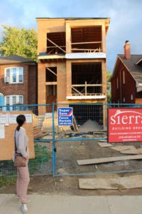 photo of monica bussoli looking at status of framed house