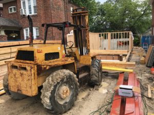 photo of lumber being moved on the construction site